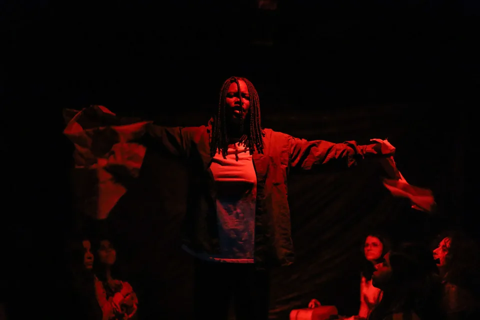 Performer on a stage lit in red